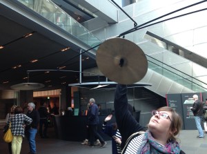 zoe suspiciously playing with a cymbal