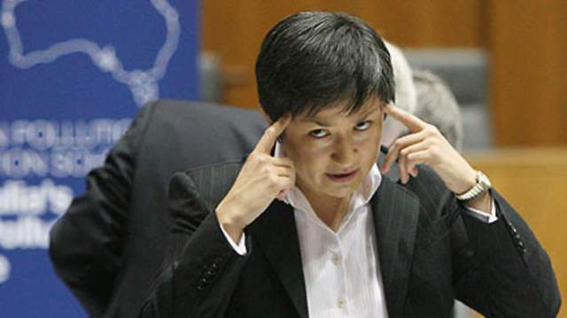 Picture of Wong with her fingers against her temples, a look of forebearance and anger on her face.