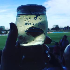 wine in a glass on a background of Whitten oval
